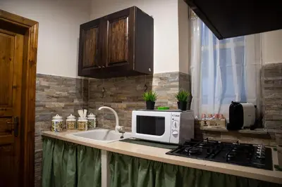 a kitchen counter with a microwave and a sink at CASA MAGIEM in Palermo