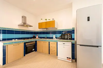 a kitchen with a refrigerator and a sink at Borgo Aranci - Villa Unifamiliare Ibiscus 08 in Castellammare del Golfo