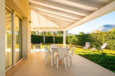 a patio with a table and chairs on it at Borgo Aranci - Villa Unifamiliare Ibiscus 08 in Castellammare del Golfo