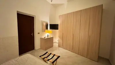 a room with a large wooden cabinet in a room at Mona House accogliente casa vacanza in Palermo