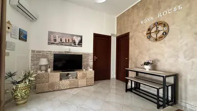 a living room with a flat screen tv on a wall at Mona House accogliente casa vacanza in Palermo