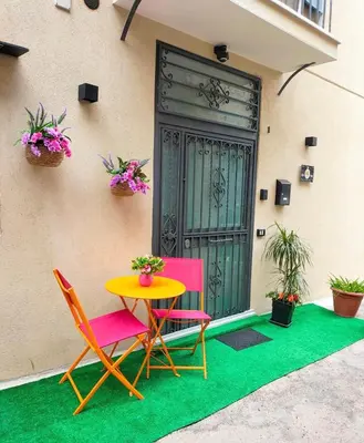 a table and two chairs on a patio with a door at Holiday home Joy in Palermo