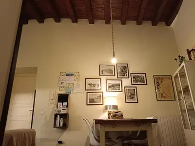 a room with a desk and pictures on the wall at We # Are ai Cassarelli in Palermo