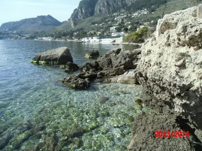a body of water with rocks and water at Holiday home Santa Flavia in Santa Flavia