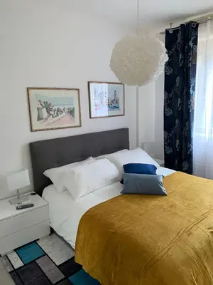 a bedroom with a large bed with a yellow blanket at Albachiara Termini in Termini Imerese