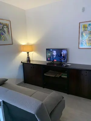 a living room with a couch and a flat screen tv at Albachiara Termini in Termini Imerese