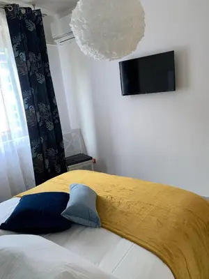 a bedroom with a bed with a yellow blanket on it at Albachiara Termini in Termini Imerese