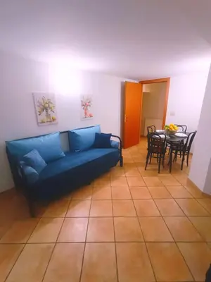 a kitchen with a wooden table and a sink at Quattro Canti - residenza Santa Caterina in Palermo