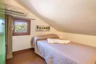 a bedroom with a bed and a window at Villa Cecilia in Cinisi