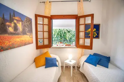 a living room with a couch and a window at Villa Reyna in Scopello