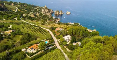 an aerial view of a house on a hill near the water at Villa Reyna in Scopello