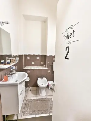 a bathroom with a toilet and a sink at B&B Villareale 35 in Palermo