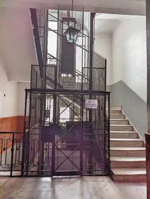a metal gate with stairs in a building at B&B Villareale 35 in Palermo