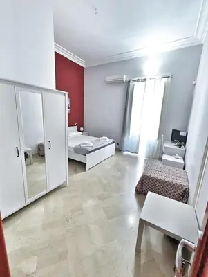 a room with a bedroom with a mirror and a bed at B&B Villareale 35 in Palermo