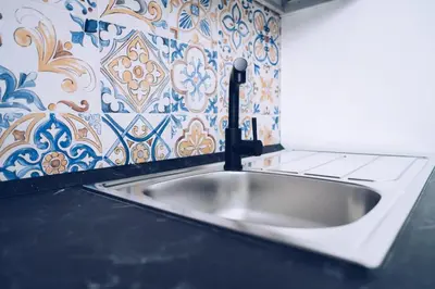 a bathroom with two toilets and a sink at Scorcio di Mare By Dimora Hub in Balestrate