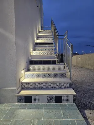a set of stairs with lights on the side of a building at Un Posto Al Sole in San Vito lo Capo
