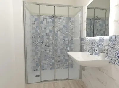 a bathroom with a sink and a glass shower at Un Posto Al Sole in San Vito lo Capo
