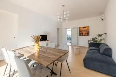 a living room with a wooden table and a couch at Villa Francesca in Carini