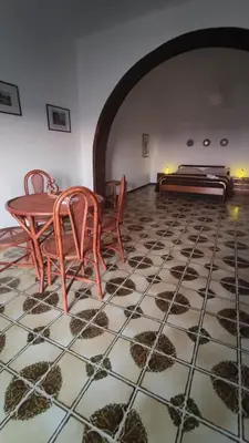 a room with a table and chairs and a bed at Casa Di Mitri in Carini