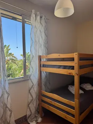 a bedroom with a bunk bed and a window at Le Casette di Campagna in Campofelice di Roccella