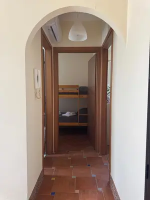 a hallway with a door leading to a bedroom at Le Casette di Campagna in Campofelice di Roccella
