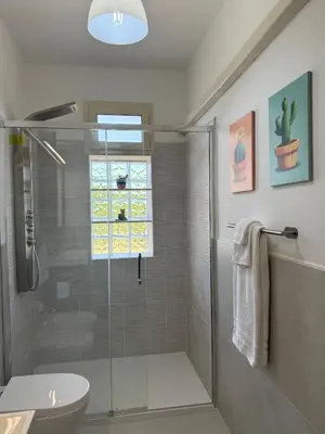 a bathroom with a shower and a toilet and a sink at Le Casette di Campagna in Campofelice di Roccella