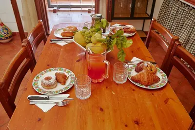 a wooden table with plates of food on it at VILLa CON PISCINA SCOPELLO in Castellammare del Golfo