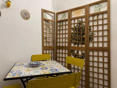 a dining room with a table and yellow chairs at Orange Lemon Center Palermo in Palermo