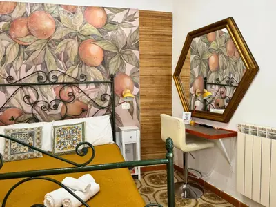 a bedroom with a bed with a painting on the wall at Orange Lemon Center Palermo in Palermo