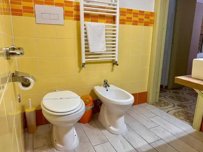 a bathroom with a toilet and a sink at Orange Lemon Center Palermo in Palermo