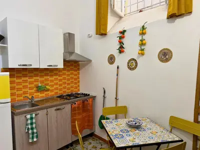 a kitchen with a table and a sink and a stove at Orange Lemon Center Palermo in Palermo