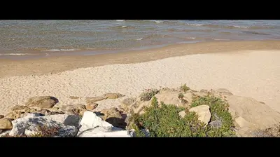 a group of rocks on a beach next to the ocean at Casa L'ORIZZONTE in Balestrate