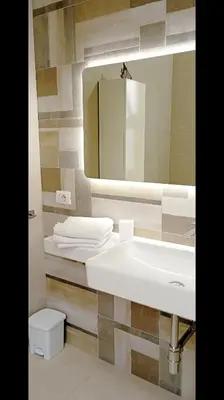 a bathroom with a white sink and a mirror at Casa L'ORIZZONTE in Balestrate