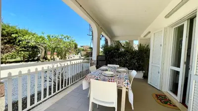 a table on the balcony of a house at Residence Cavalluccio Marino in Alcamo Marina