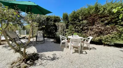 a table and chairs and an umbrella in a yard at Residence Cavalluccio Marino in Alcamo Marina