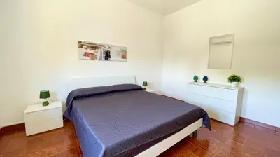 a bedroom with a bed and two night stands at Residence Cavalluccio Marino in Alcamo Marina