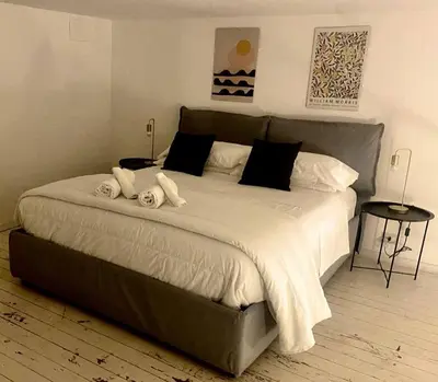 a bedroom with a large bed with towels on it at Cathedral cozy apartment in Palermo