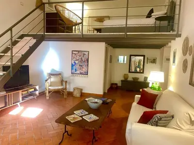 a living room with a couch and a table at Cathedral cozy apartment in Palermo