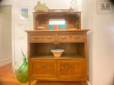 a wooden cabinet with a bowl in a room at Cathedral cozy apartment in Palermo