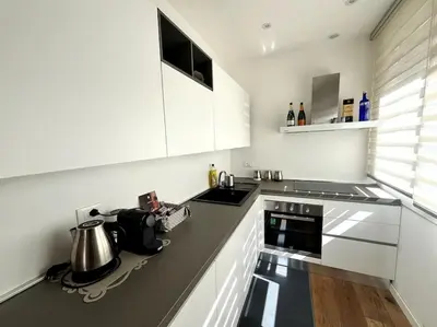 a kitchen with white cabinets and a stove top oven at Lazio apartment nel centro di Palermo in Palermo