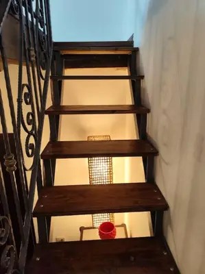 a set of wooden stairs with a red bowl on them at Casa Bosco a Ballarò in Palermo