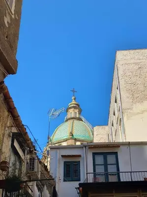 a building with a green dome on top of it at Casa Bosco a Ballarò in Palermo