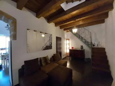 a living room with a couch and a staircase at Casa Bosco a Ballarò in Palermo
