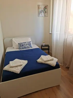 a bedroom with a bed with towels on it at Holiday House Nonna Grazia in Trappeto