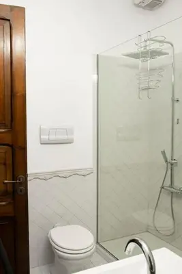 a bathroom with a toilet and a glass shower at Cavour Elegant apartment At Massimo Theater in Palermo