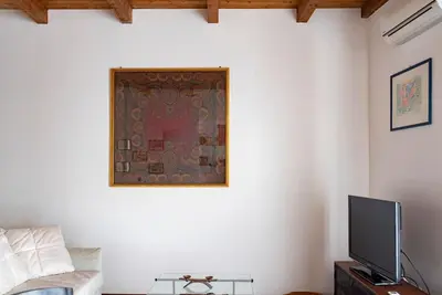a living room with a flat screen tv on a wall at Cavour Elegant apartment At Massimo Theater in Palermo