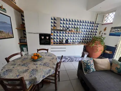 a living room with a table and a couch at 'a casetta - Sferracavallo in Palermo