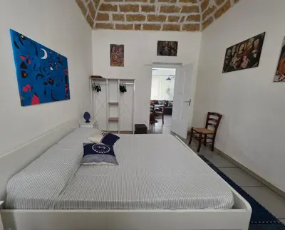 a bedroom with a large bed in a room at 'a casetta - Sferracavallo in Palermo