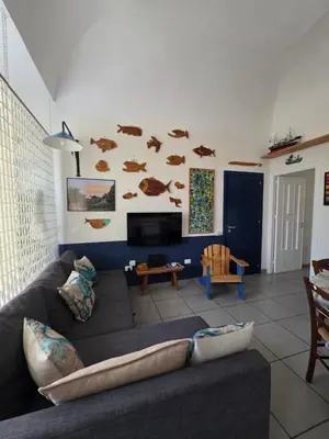 a living room with a couch and a tv at 'a casetta - Sferracavallo in Palermo