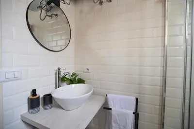 a bathroom with a bowl sink and a mirror at iFlat Casa Viscuttara in Palermo